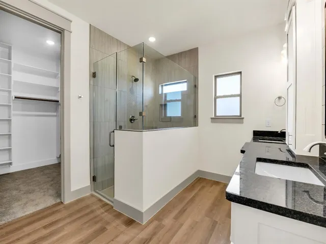 a kitchen with a refrigerator and a stove top oven