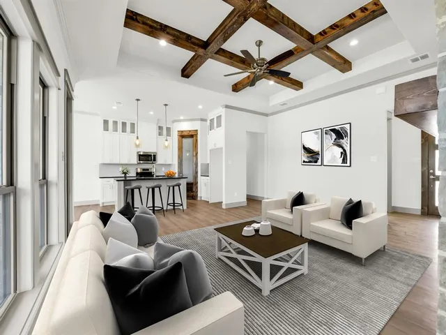 a living room with furniture ceiling fan and a rug