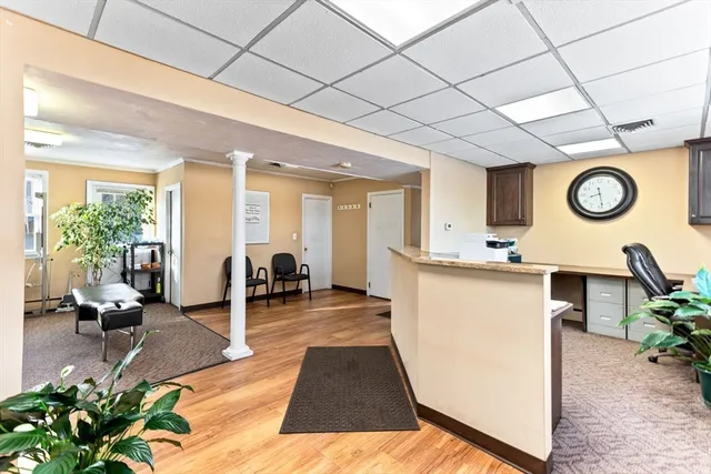 a view of living room with furniture and wooden floor