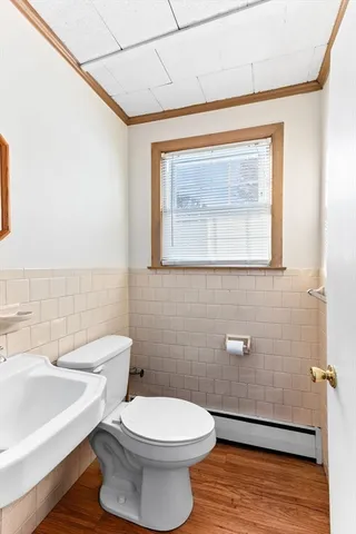 a bathroom with a toilet a sink and mirror