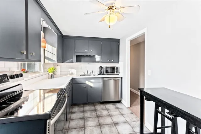 a kitchen with a sink a stove cabinets and counter space