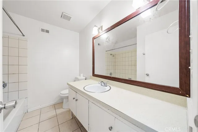 a bathroom with a granite countertop sink a mirror and a shower