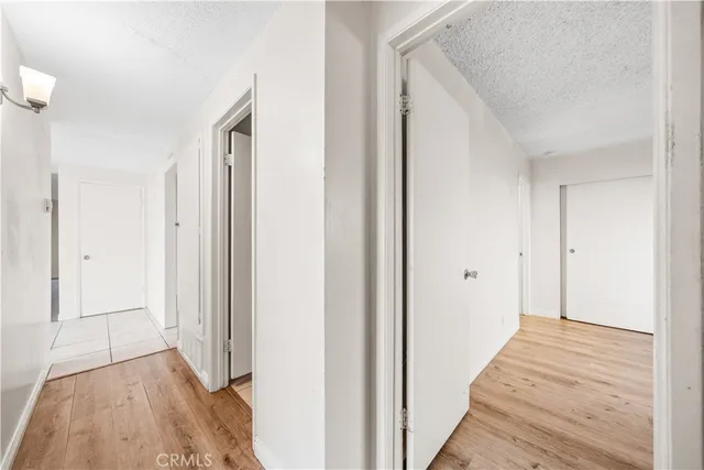a view of a hallway with wooden floor and entryway