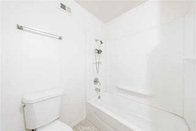 a bathroom with a bathtub and a toilet