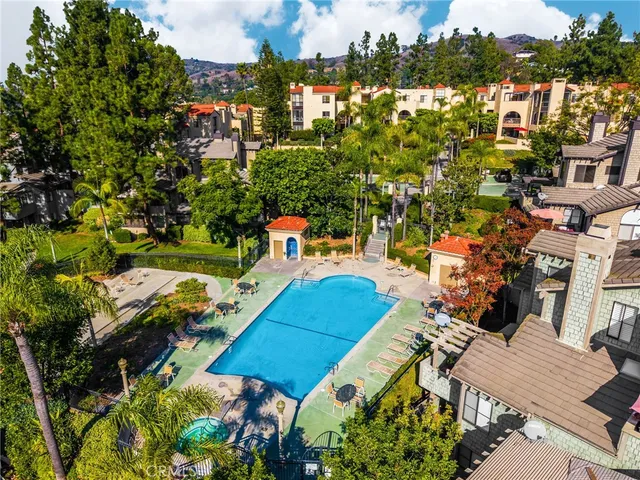 an aerial view of a house swimming pool a patio and outdoor seating