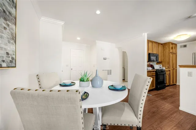 a living room with furniture and kitchen