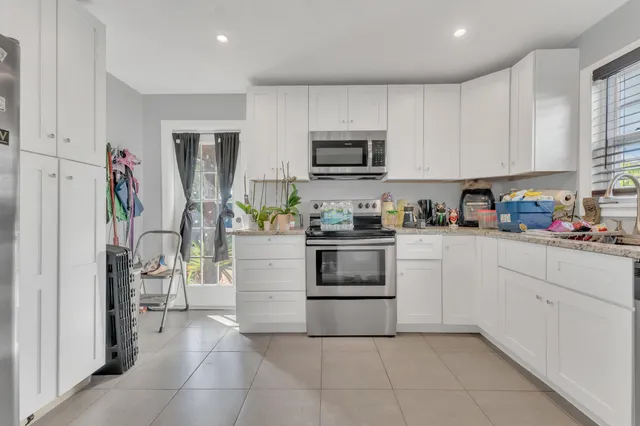 a kitchen with cabinets and appliances