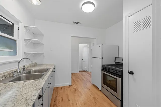 a kitchen that has a sink and a stove