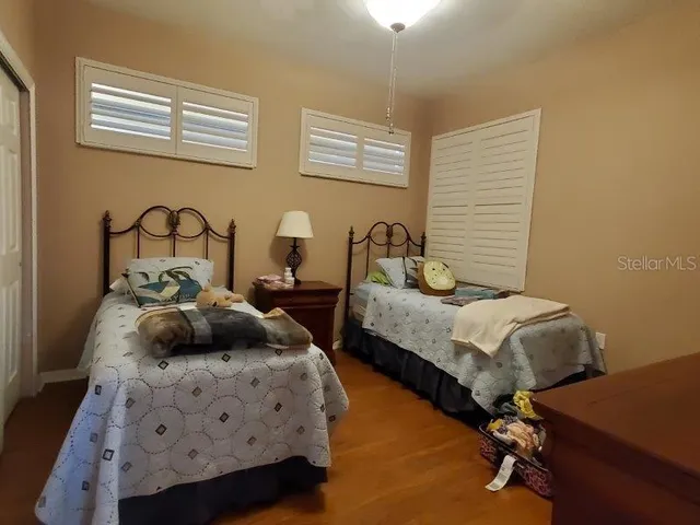 a bedroom with two beds and a dresser