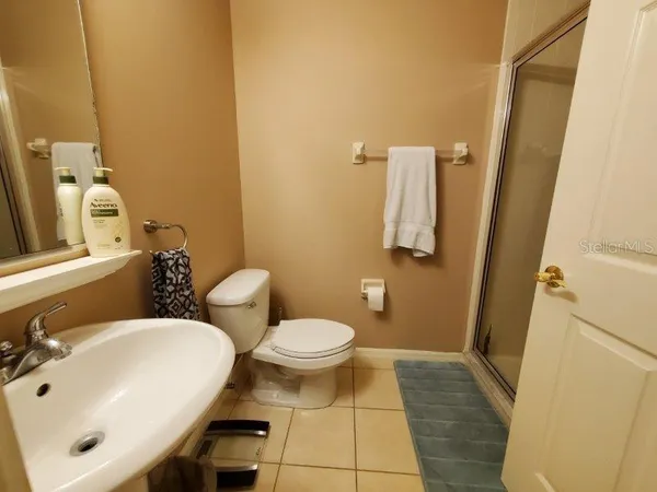 a bathroom with a sink toilet and mirror