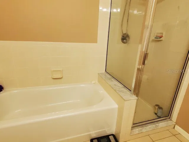 a bed sitting in a bedroom next to a lamp