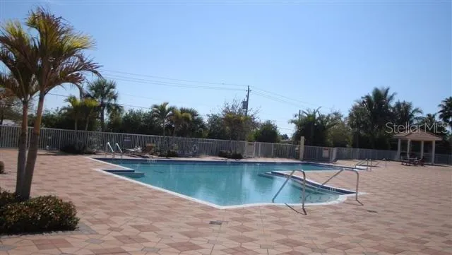 a front view of a house with a garden and palm tree