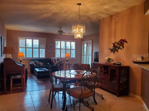 a view of a dining room with furniture and chandelier