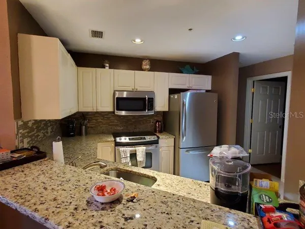 a kitchen with a stove a refrigerator and a sink