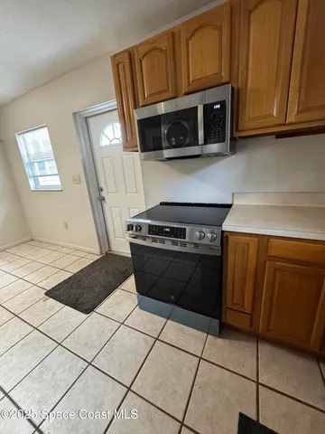 a stove top oven sitting inside of a kitchen
