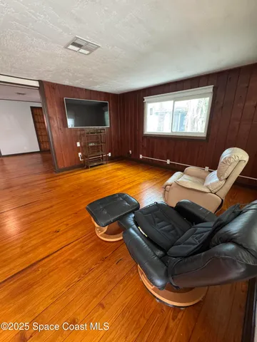 a room with furniture flat screen tv and windows