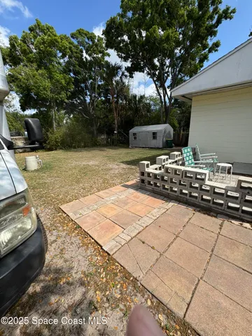 a backyard of a house with lots of green space and trees