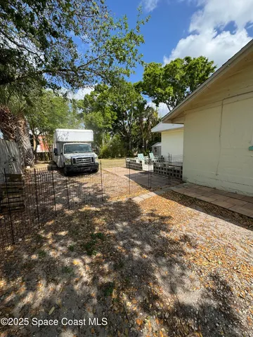 a view of a backyard with sitting area