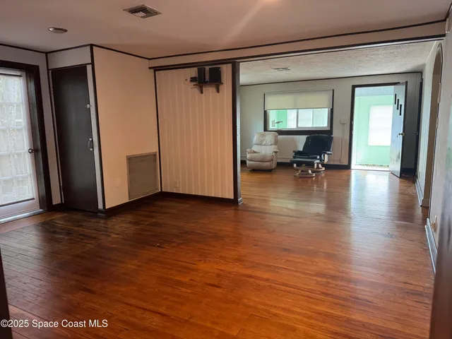 a view of livingroom with hardwood floor and furniture