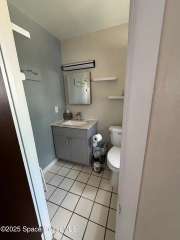 a bathroom with a sink toilet and mirror