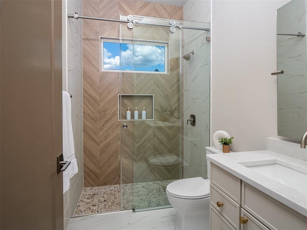 14828 Southwest 9th Lane Newberry, FL 32669 - Photo 29 of 45 a bathroom with a granite countertop sink toilet and shower