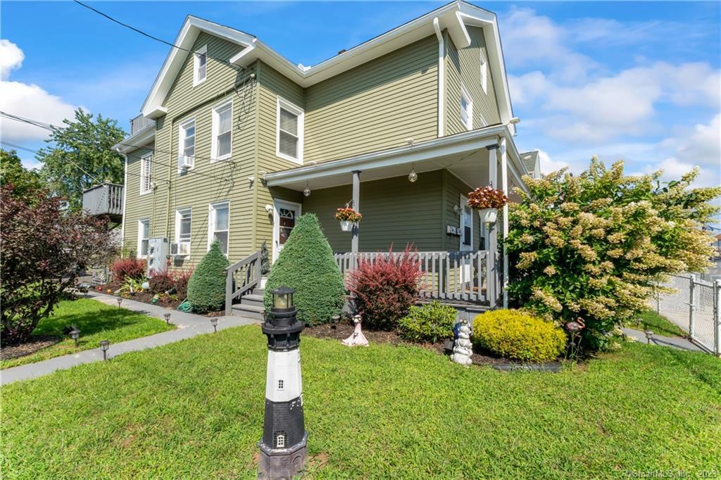 9 Hayes Street Bridgeport, CT 06608 - Photo 1 of 1 a front view of a house with a garden and plants