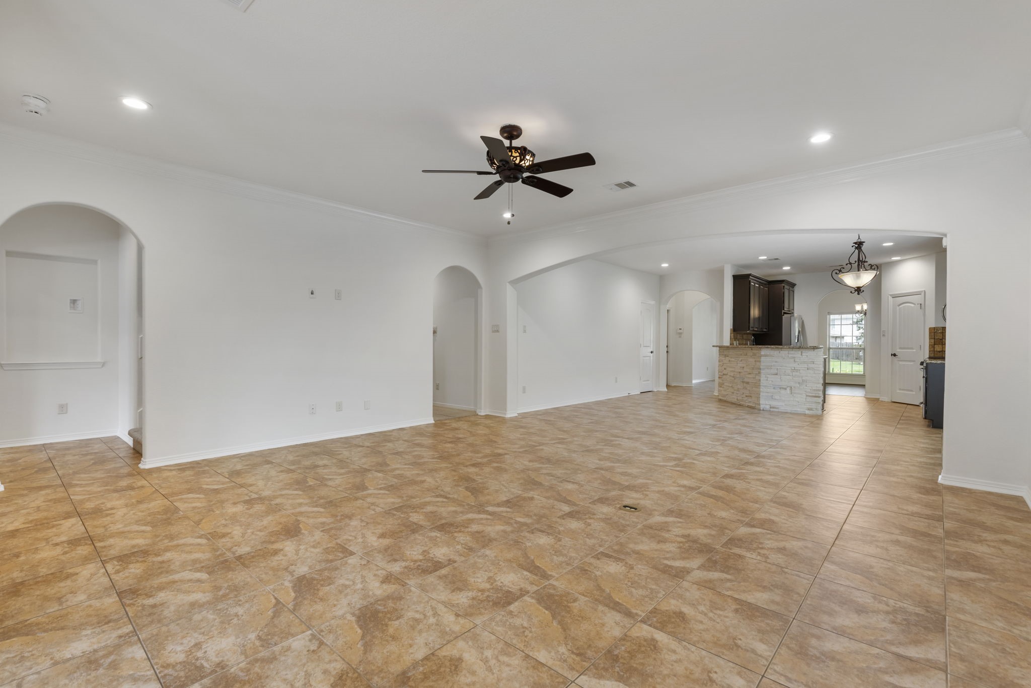 23911 Augusta Falls Lane Spring, TX 77389 - Photo 13 of 40 a view of a kitchen with a sink and a chandelier fan