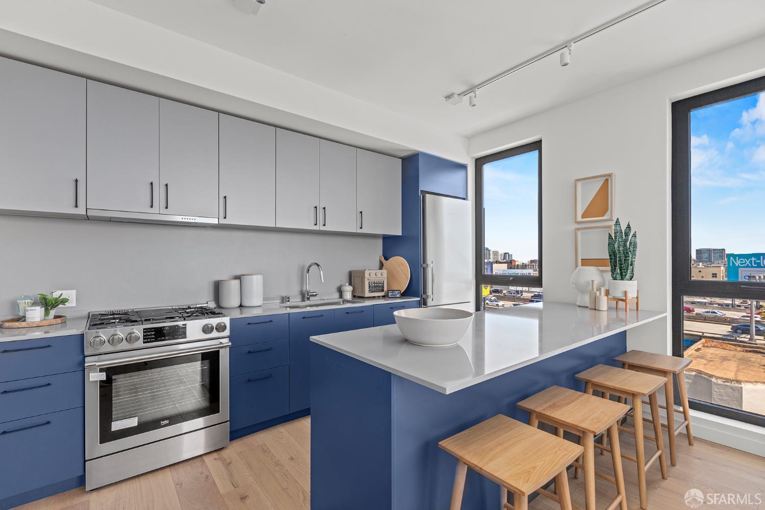 988 Harrison Street, Unit HM6 San Francisco, CA 94107 - Photo 2 of 14 a kitchen with a stove a sink and a refrigerator