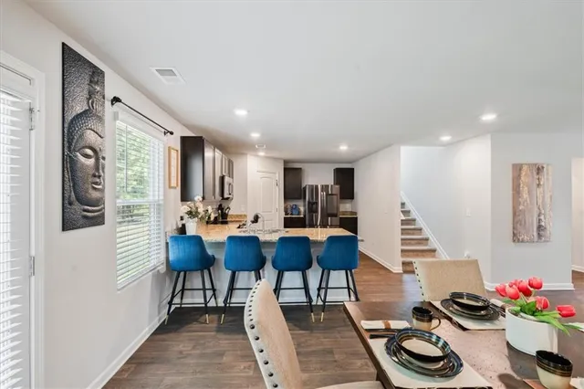 a view of a dining room with furniture and a potted plant