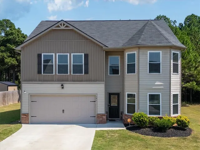 a front view of a house with a yard