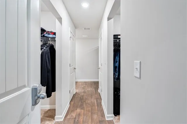 a view of hallway with wooden floor