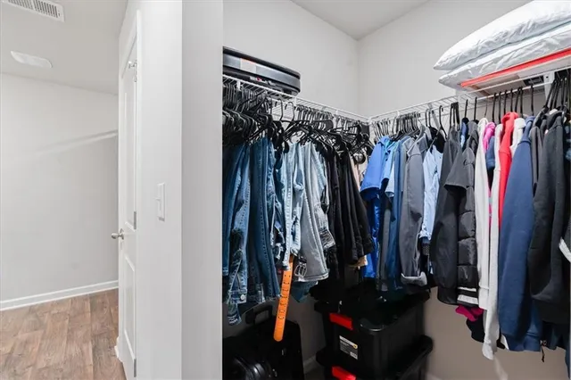 a view of walk in closet with clothes