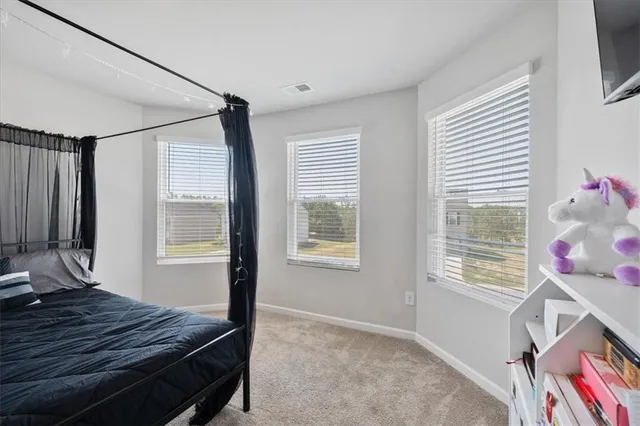 a bedroom with a bed window and flowerpot