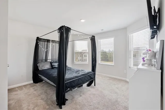 a bed room with a bed and a window