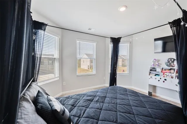 a bedroom with a bed and a window