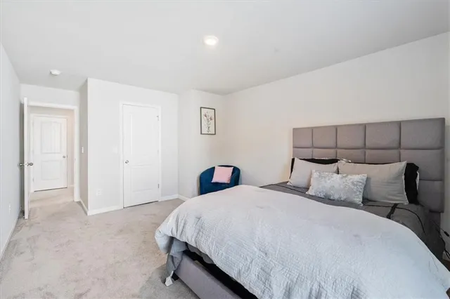 a bedroom with a bed and a night stand