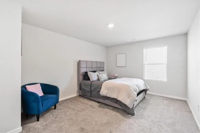 a spacious bedroom with a bed and a window