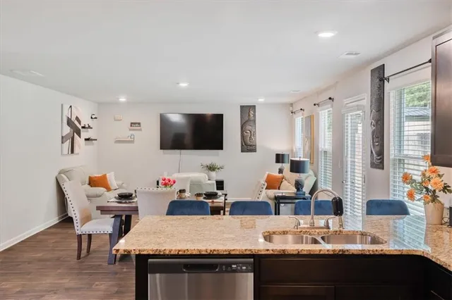a living room with granite countertop furniture and a flat screen tv