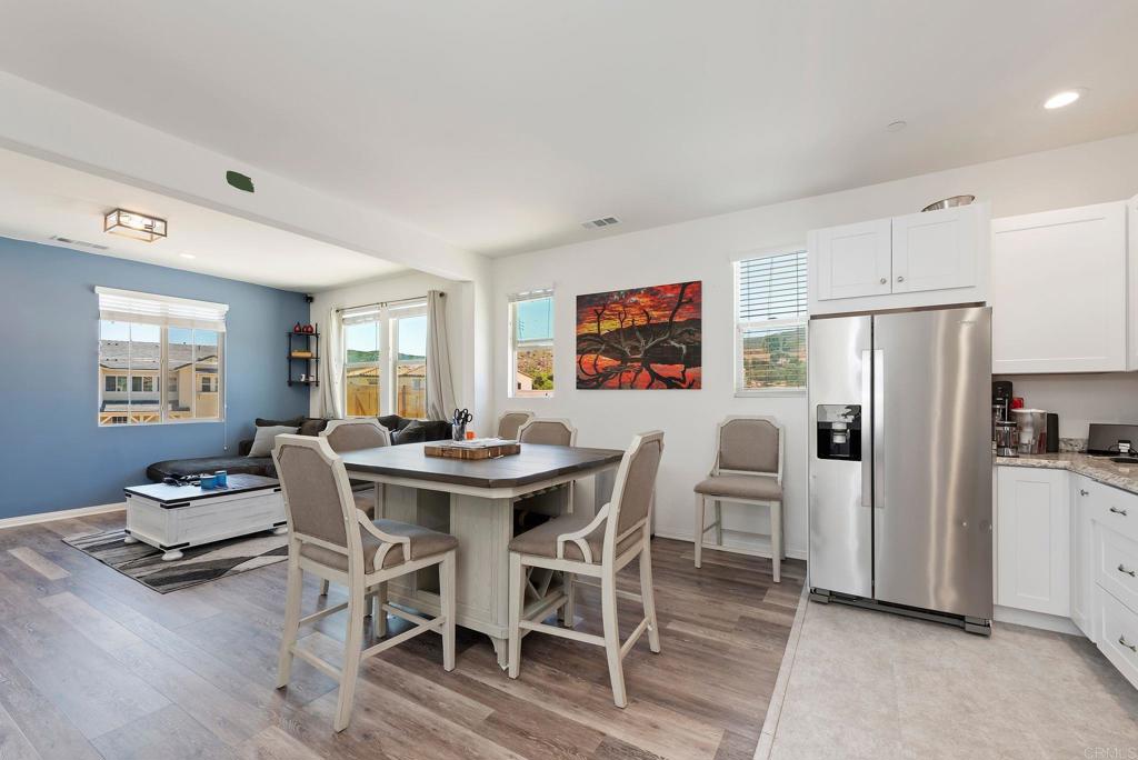 22089 Gallop Way Escondido, CA 92029 - Photo 23 of 43 a view of a dining room with furniture a rug and wooden floor