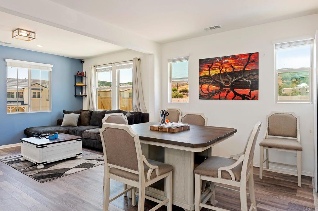 22089 Gallop Way Escondido, CA 92029 - Photo 27 of 43 a dining room with furniture a window and wooden floor