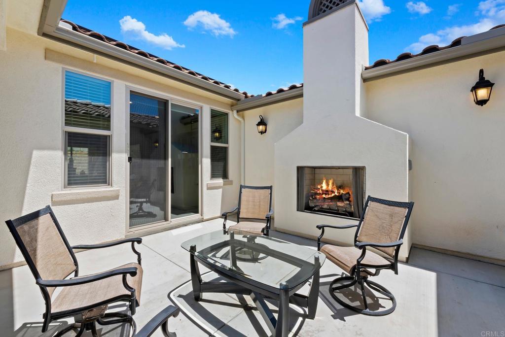22089 Gallop Way Escondido, CA 92029 - Photo 3 of 43 a outdoor space with patio furniture and a fireplace