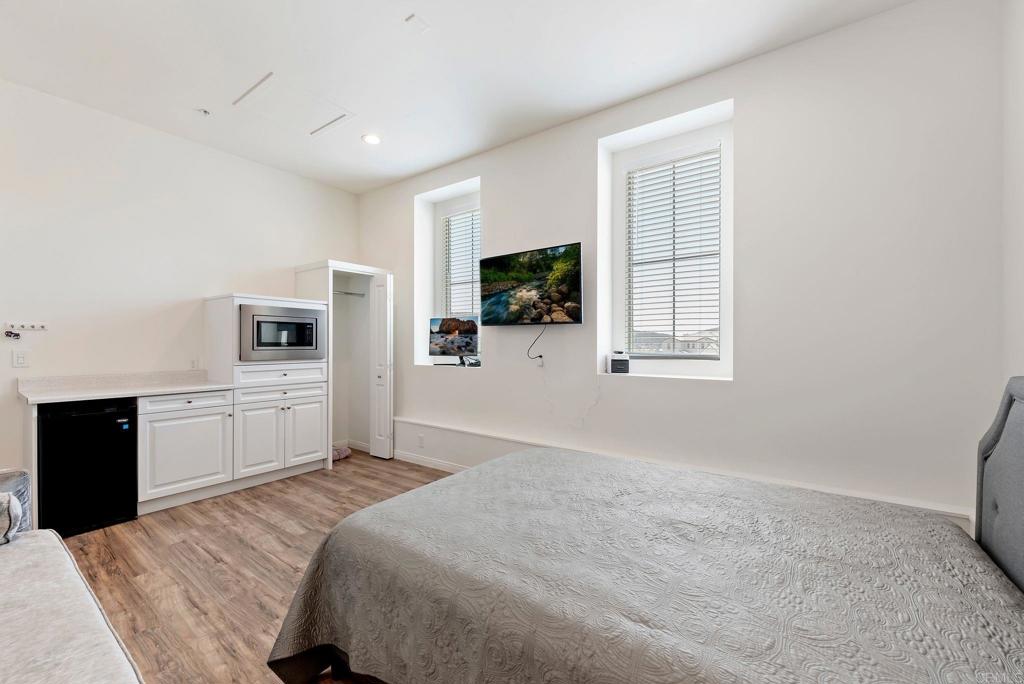 22089 Gallop Way Escondido, CA 92029 - Photo 31 of 43 a bedroom with a large bed and a flat screen tv