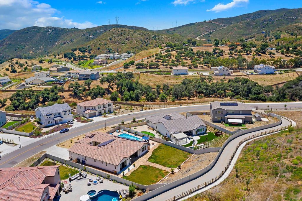 22089 Gallop Way Escondido, CA 92029 - Photo 41 of 43 an aerial view of a house with a swimming pool and mountains