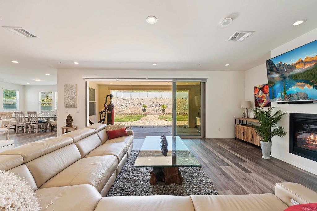 22089 Gallop Way Escondido, CA 92029 - Photo 8 of 43 a living room with fireplace furniture and a flat screen tv