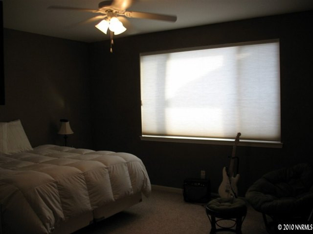 10612 Fire Poppy Circle Reno, NV 89521 - Photo 8 of 9 a bedroom with a bed and a window