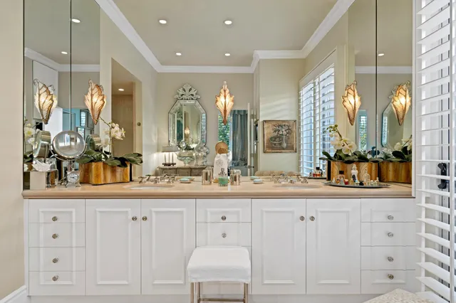 a bathroom with double vanity and a mirror