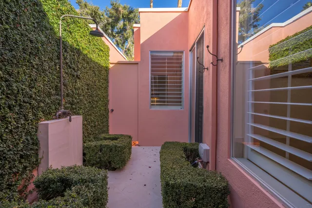 a couple of potted plants in front of a door