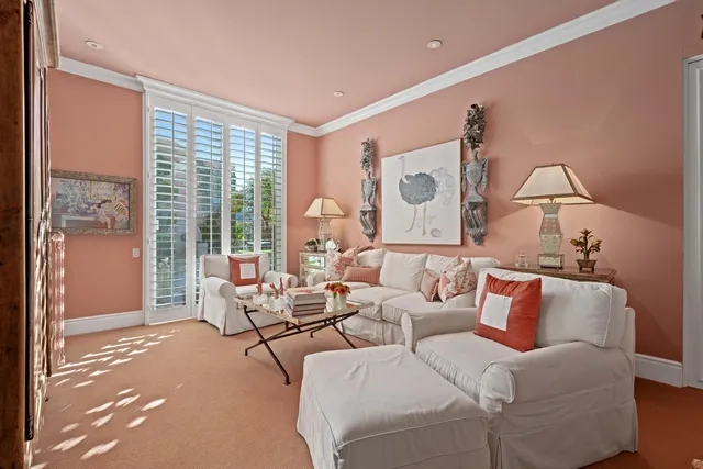 a living room with furniture and large windows