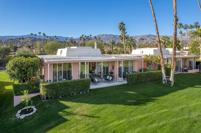 a front view of a house with a garden and porch