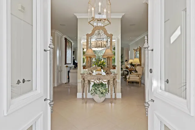 a view of a dining room with chandelier fan and wooden floor